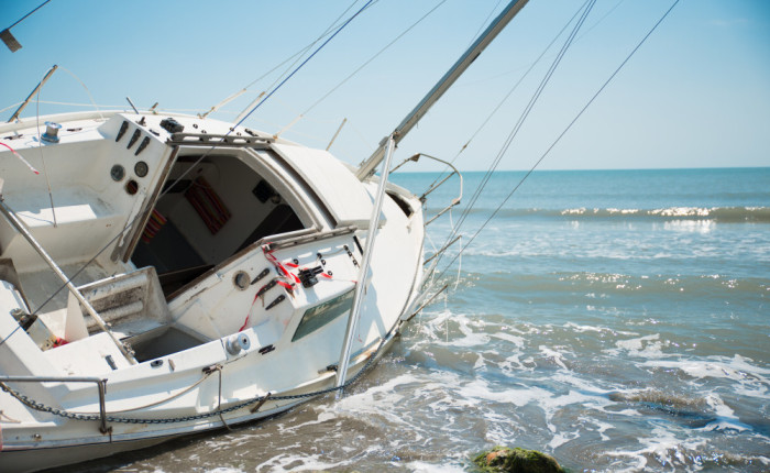 sailboat wrecked and stranded on beach